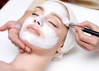 A bride-to-be preparing for her wedding by receiving a facial