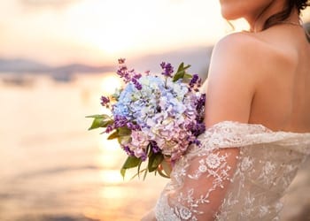A bride holding a bouquet during as summertime wedding