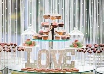 Perfectly Beautiful Modern Wedding Display A cake pop and cupcake stand at a modern-themed wedding reception