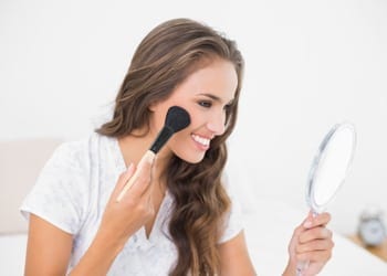 A bride to be who has researched the best methods with which to apply her makeup