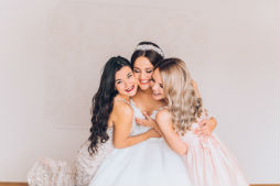 Bride and Bridesmaids hugging 