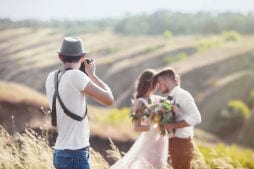 Wedding photographer taking photos of bride and groom