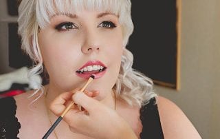 Sarah applying lipstick