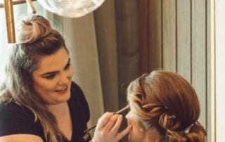 Cara applying wedding makeup